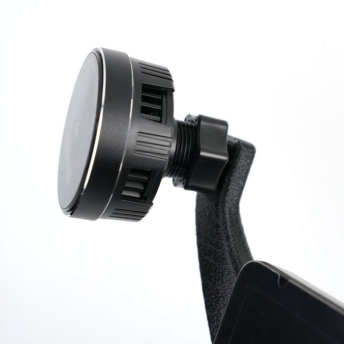 Close-up of a black magnetic car phone mount with an adjustable screw and a phone partially visible in the holder against a white background.