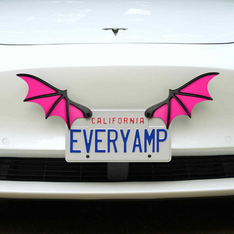 A white car with a California license plate EVERYAMP is adorned with EveryAmps magenta License Plate Bat Wings. This unique setup includes SnapPlates made from recycled PETG plastic for a stylish and sustainable display.