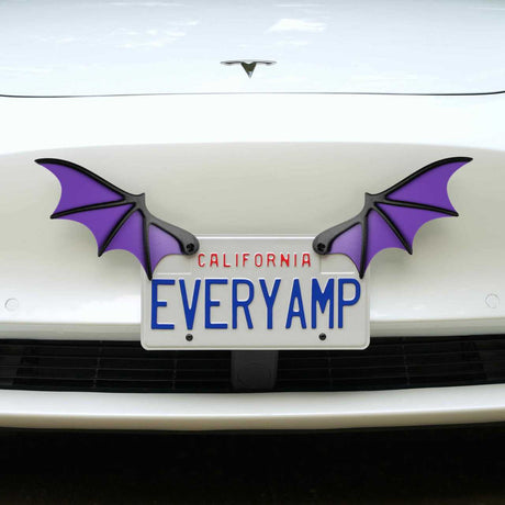 A white car with a California license plate EVERYAMP features two License Plate Bat Wings by EveryAmp, in purple, crafted from recycled PETG plastic for an eco-friendly touch.