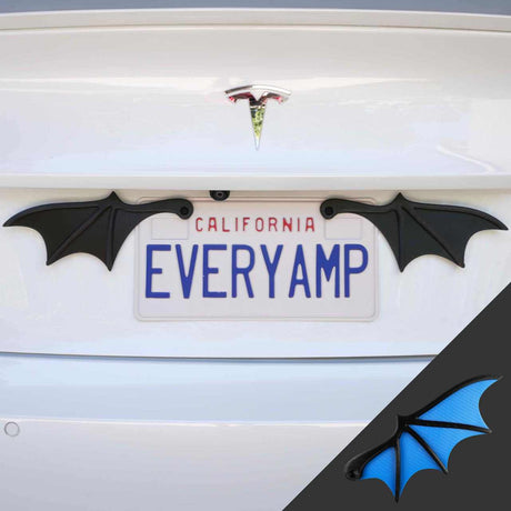 Tesla with California license plates saying EVERYAMP features License Plate Bat Wings by EveryAmp, crafted from recycled PETG plastic. A black wing image with a blue underlayer in the corner embodies innovation and style.