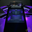 Overhead view of a car with all doors open, illuminated by Abstract Oceans Ultrabright Lights for Cybertruck in vivid purple.
