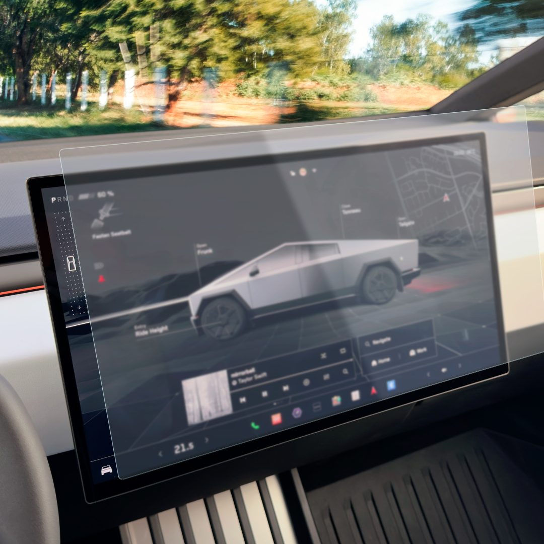 A close-up of a vehicle dashboard showcases a digital display with a futuristic truck image, menus, and navigation details, protected by Abstract Oceans Ultra-Premium Tempered Glass (9H) Screen Protectors for Cybertruck. Trees can be seen through the windshield in the background.