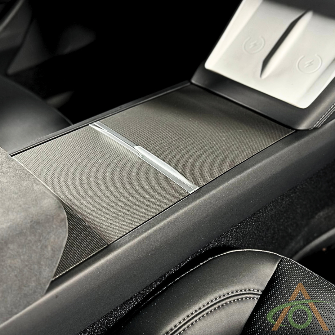 Close-up of a Refreshed Model 3 & Y center console fitted with Abstract Ocean's Center Console Vinyl Wrap, showing the sliding cover, cup holders below, and nearby leather seats.