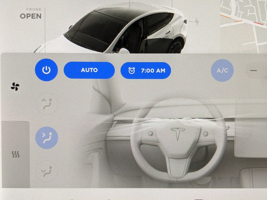 Close-up of a Tesla cars interior display screen showing climate control settings with options for auto mode, scheduled start, and air conditioning features.