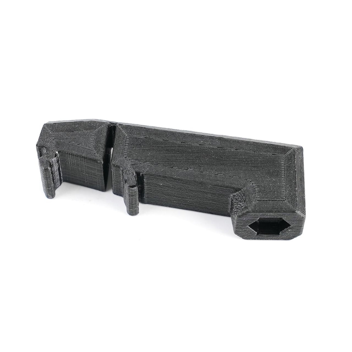 The Dash Anchor Part for Rivian R1T & R1S (2022+) by EveryAmp is a black, 3D-printed component made from durable PolyHex plastic. Featuring angled and curved edges with small protrusions and an indent, its proudly made in the USA for precision applications like ball mounts.