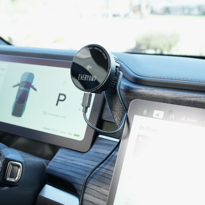 A black car dashboard phone mount is attached to a vent, holding a charging cable. Two digital screens display navigation details and a parked car symbol.