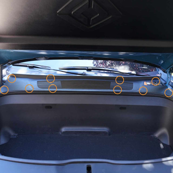 Open car trunk showing an interior panel with multiple highlighted attachment points.