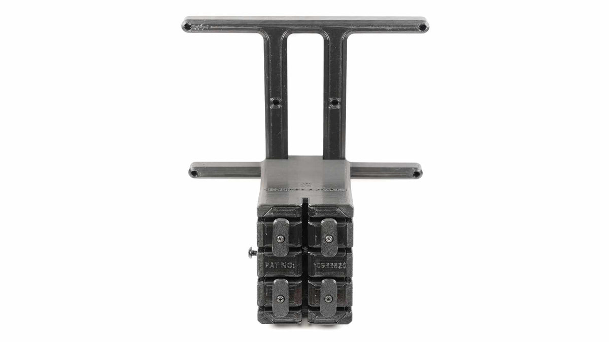 A black plastic dual cable comb with a mounting bracket, designed for cable management in computer setups.