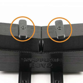 Black plastic mount with two protruding tabs, each circled in orange, and labeled Snapplate EU V2 at the bottom.