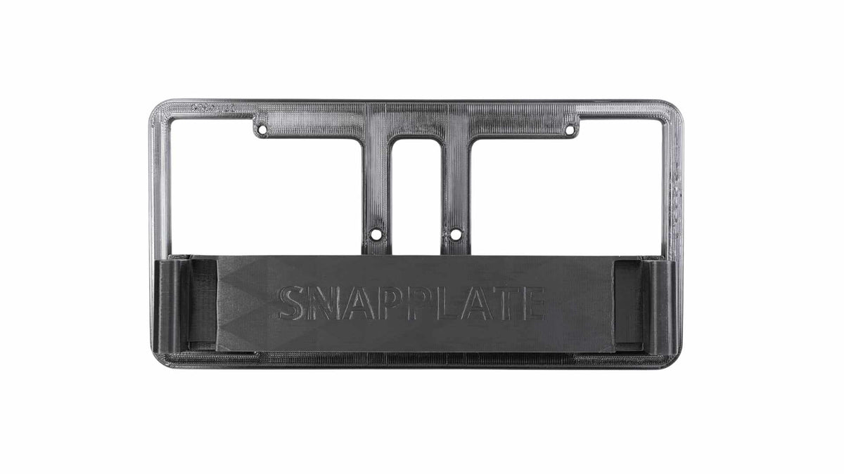 A black SnapPlate license plate holder with mounting holes and a central embossed brand name.