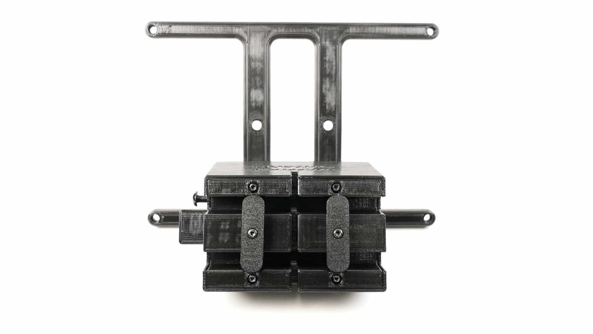 A black 3D-printed mount with holes for wall attachment, featuring two symmetrical sections held together by screws.