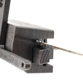 Close-up of a 3D-printed plastic holder gripping a thin metal rod, viewed from an angle with a white background.