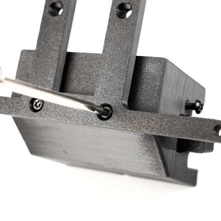 Close-up of a screwdriver being used to tighten a screw on a black metal bracket.