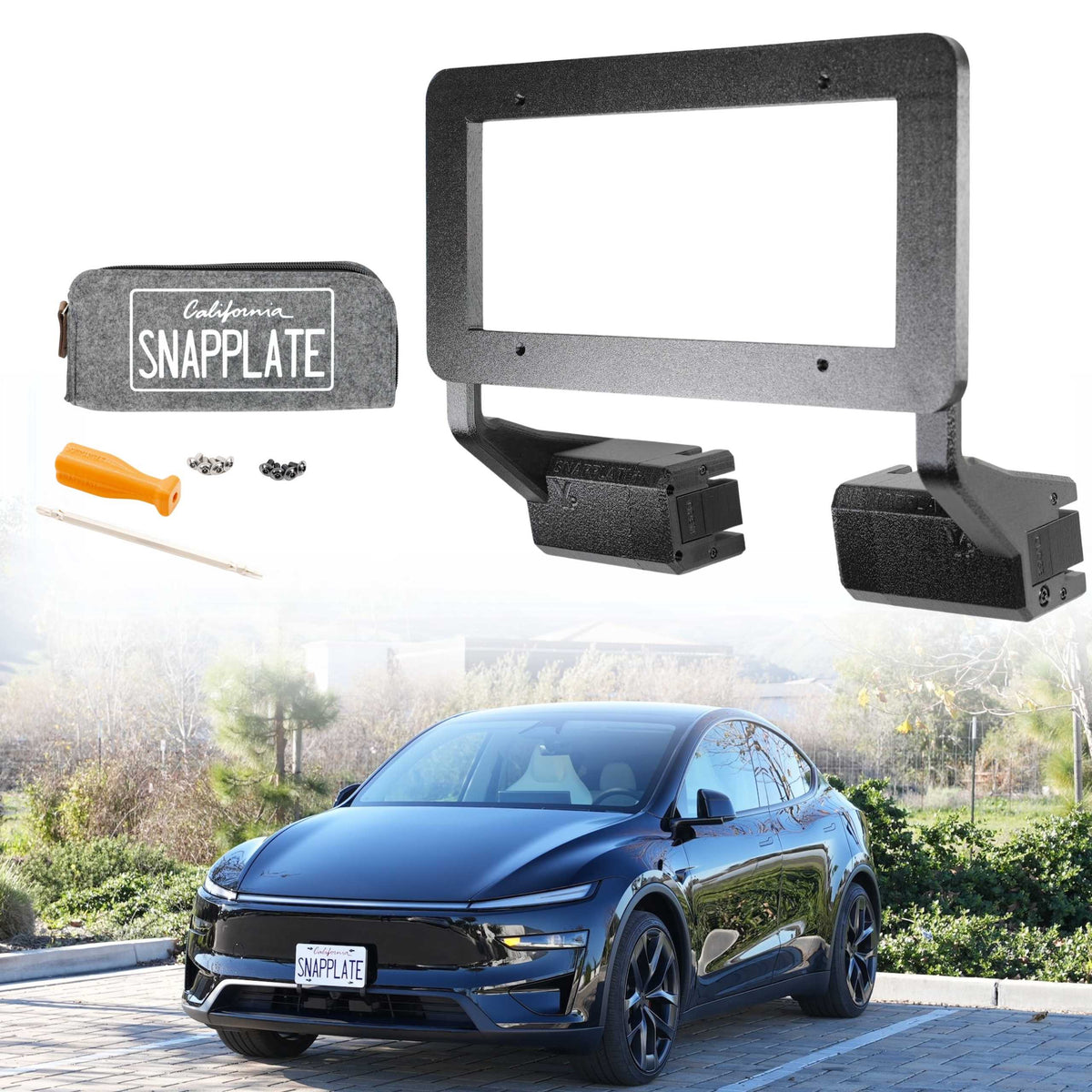 An EveryAmp Tesla Model Y SnapPlate Front License Plate Holder in black is shown above a blue car with a front license plate, parked outdoors on a stone driveway with trees.