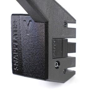 Close-up of a black, 3D-printed plastic component with the word SNAPPLATE+ embossed on the side, featuring mounting slots and a screw.