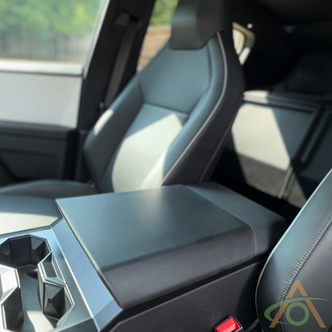 A modern vehicles interior features two black upholstered seats and a central console, enhanced by Abstract Oceans Protective Armrest Cover For Cybertruck made of sleek TPU for added style and durability during adventures.