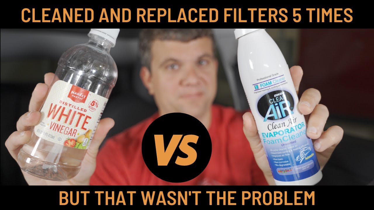 A person holds a vinegar bottle in one hand and an evaporator cleaner in the other, with text reading Cleaned and replaced filters 5 times VS But that wasnt the problem.