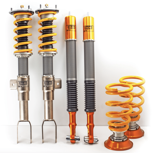 A set of Öhlins adjustable car coilover suspension components, including struts, springs, and dampers, displayed upright against a plain background.