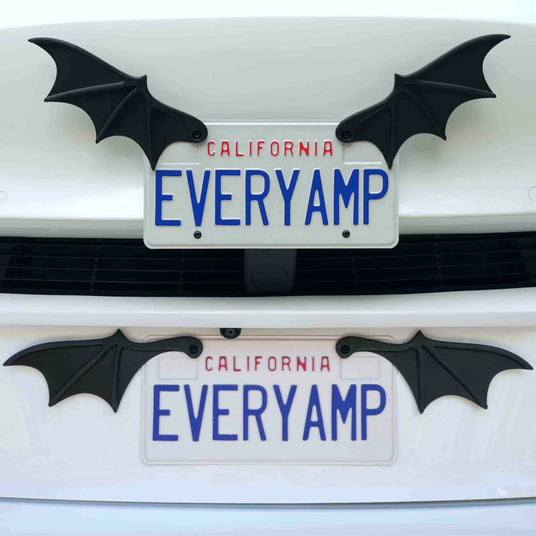 California license plates reading EVERYAMP are affixed to a car, each with black bat-wing decorations on either side.