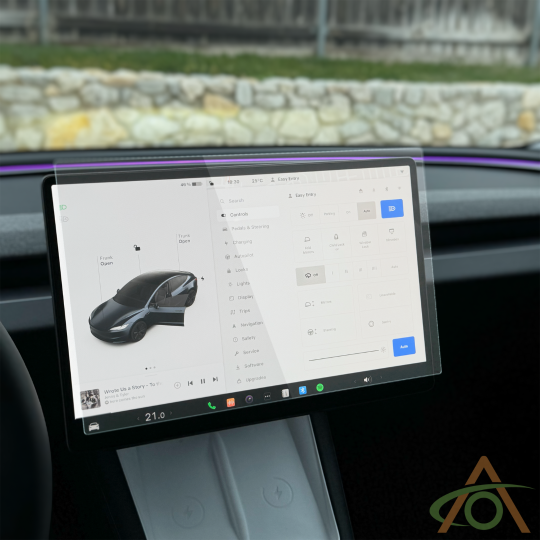 A Tesla dashboard features an Abstract Ocean Ultra-Premium Tempered Glass (9H) Screen Protector for the refreshed Model 3 & Y, displaying vehicle status, climate controls, and apps, with a road and stone wall visible outside.