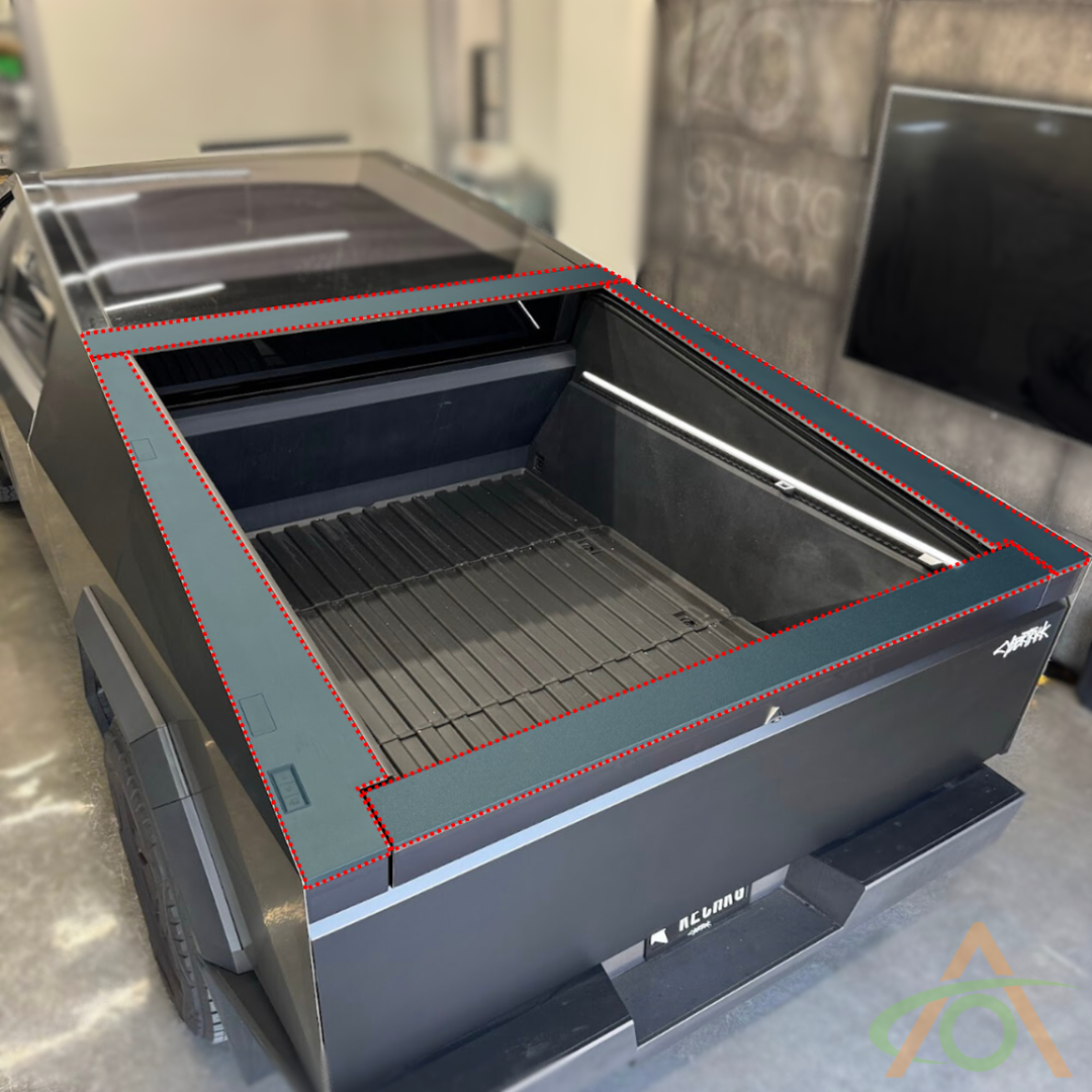 An Ultra-Tough Xpel Armor Bed Protection for Cybertruck by Abstract Ocean, featuring a futuristic angular design and open truck bed with sleek trim, sits inside a garage.