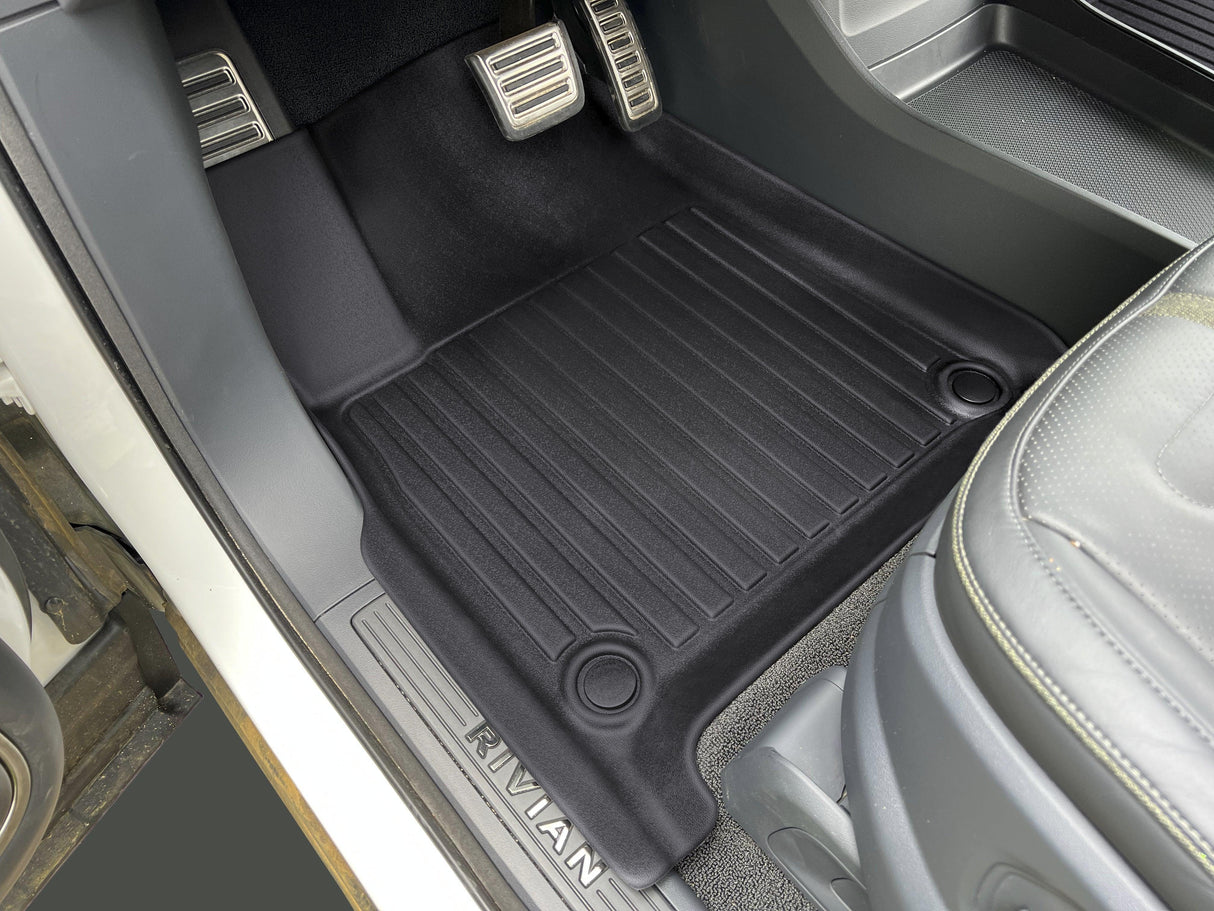 Drivers side of the Rivian R1S is equipped with LinerX Floor Mats for 2022-2024 models and silver pedals, combining rugged elegance with advanced performance.