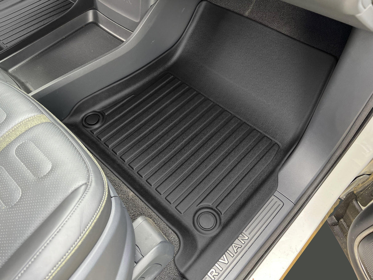 The LinerX Floor Mats for 2022-2024 Rivian R1T, made from Thermoplastic Elastomer, feature a ribbed texture and RIVIAN branding. These Advanced Performance Mat Liners are designed to fit the front passenger footwell perfectly.