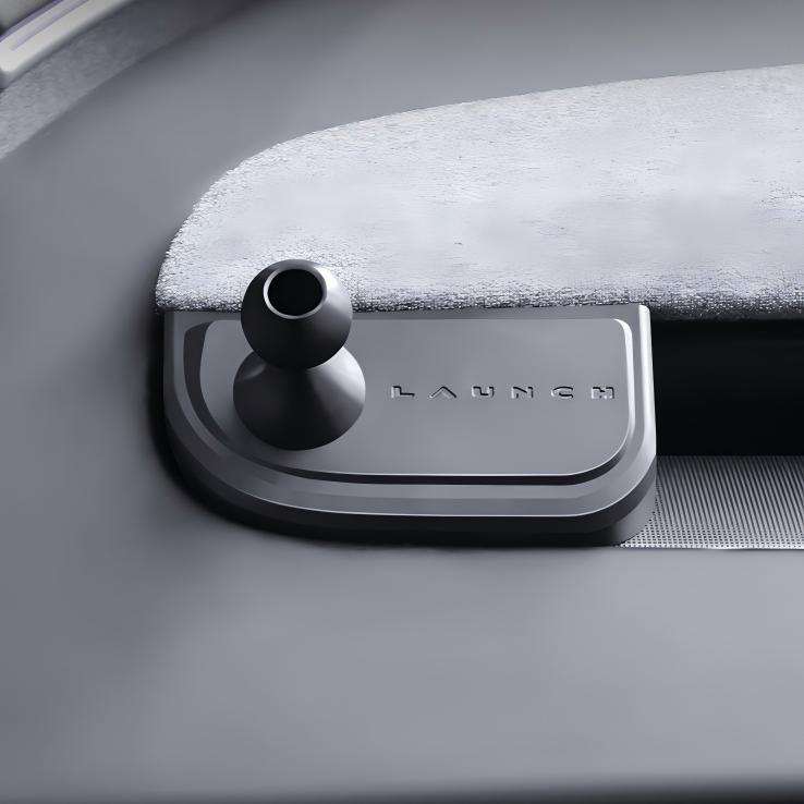 A close-up of a metallic LAUNCH button on a sleek control panel next to the Tesery Official Store Magnetic Dashboard Phone Mount for Model 3 Highland / Model Y Juniper.