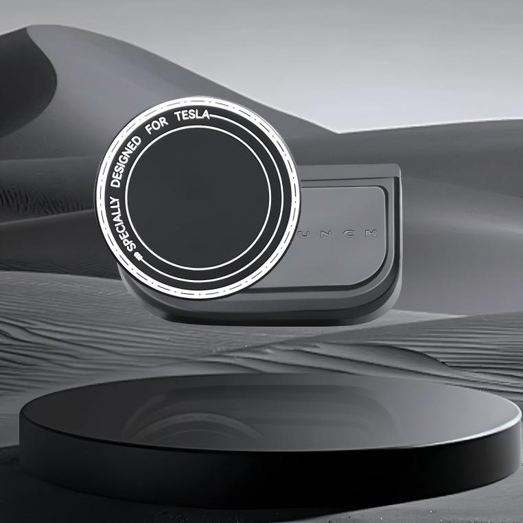 A round black device labeled Tesery Official Store sits on a black stand with a desert-like background, highlighting its sleek design as the Magnetic Dashboard Phone Mount for Model 3 Highland/Model Y Juniper.