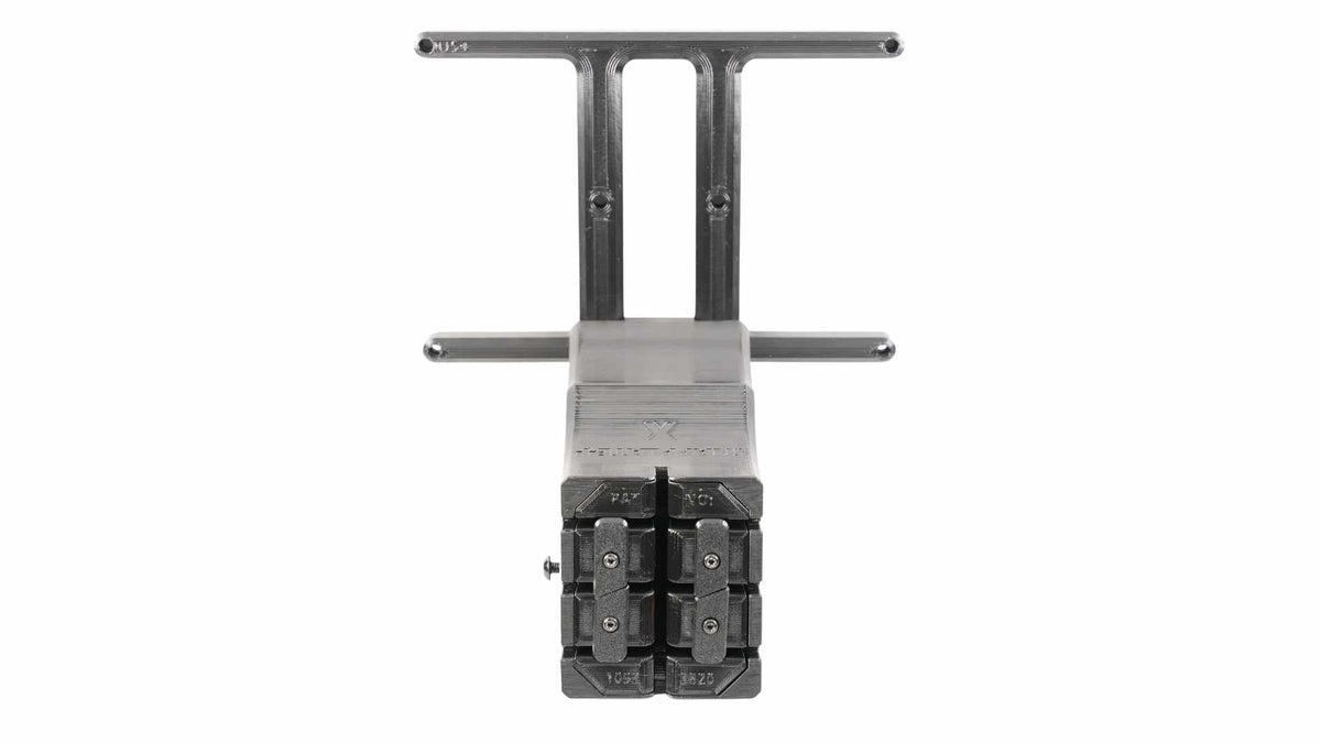 Close-up view of a steel cable tensioning tool featuring adjustable clamps and marked measurements.