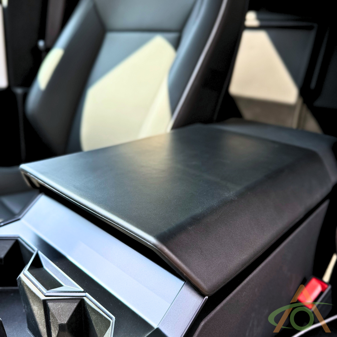 The car interior boasts an Abstract Ocean armrest with cup holders in a geometric design, enhanced by the Protective Armrest Cover For Cybertruck for added protection.