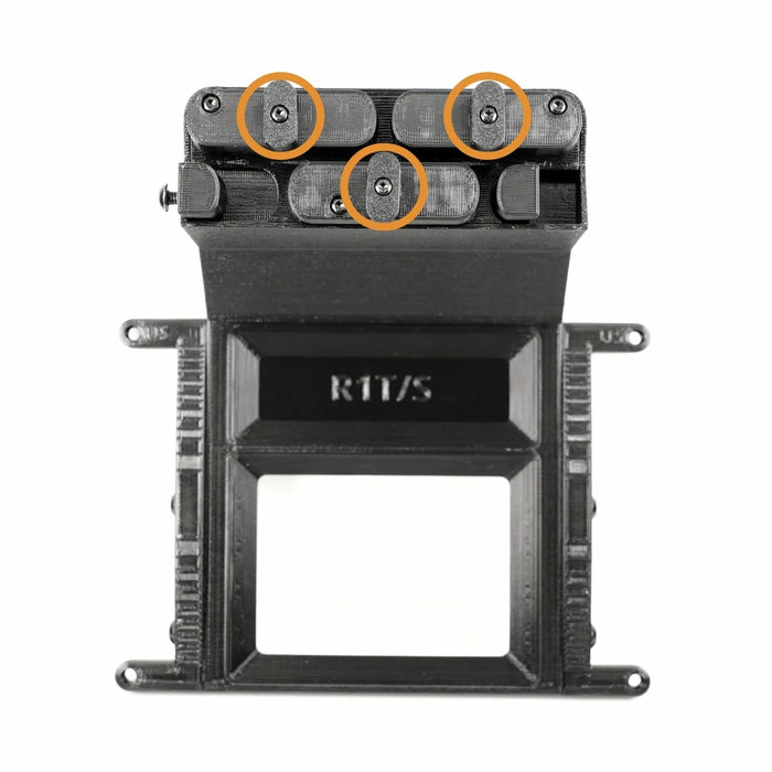 Black mechanical component with three orange circles highlighting screws on the top section. The lower portion has a rectangular frame and markings, R11/S, along with notches on the sides.