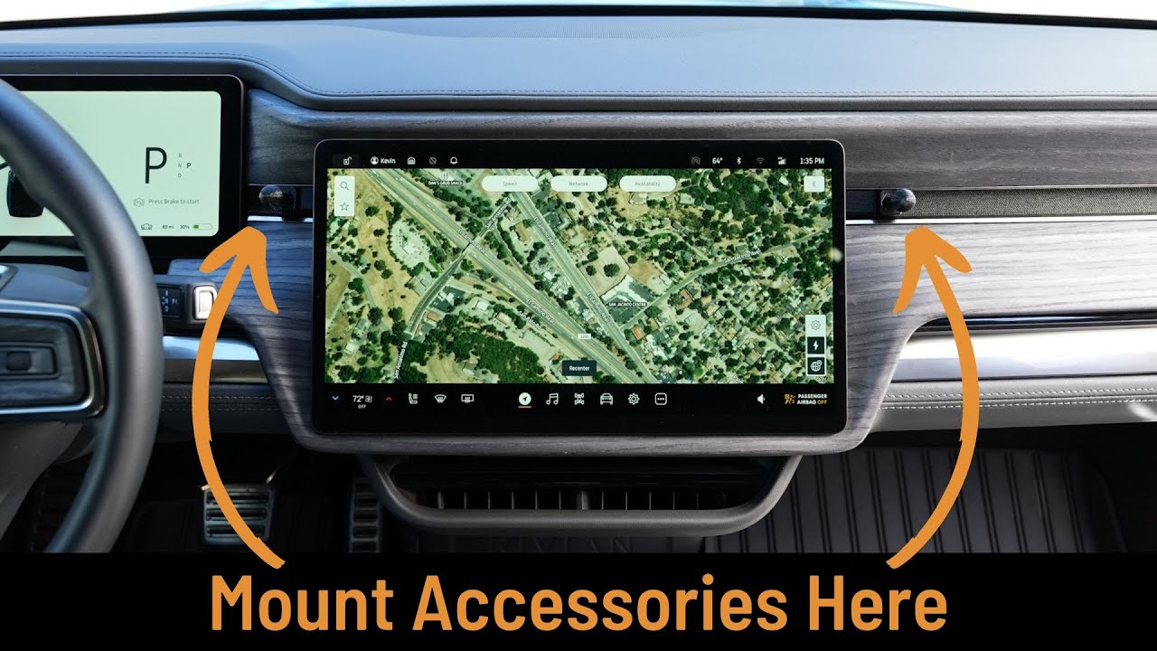 Car dashboard featuring a large digital map display and a smaller display on the left. Two arrows highlight areas labeled Mount Accessories Here.