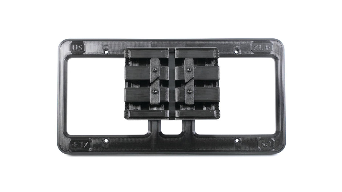 A black rectangular plastic frame with an adjustable, grid-like mechanism at the center, designed for mounting or holding objects.