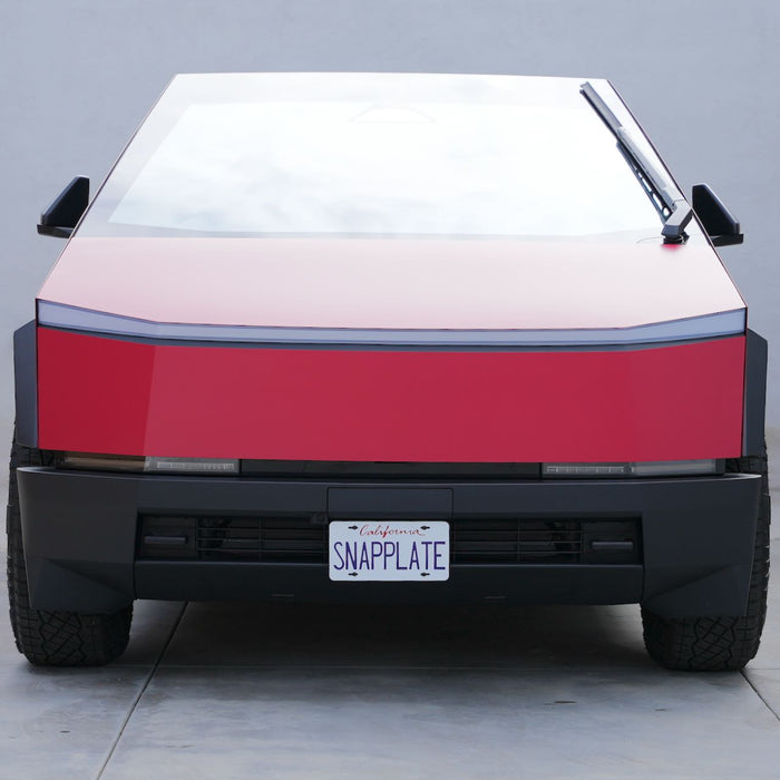 Red, futuristic-looking vehicle with a geometric design, viewed from the front, displaying a license plate reading SNAPPLATE.