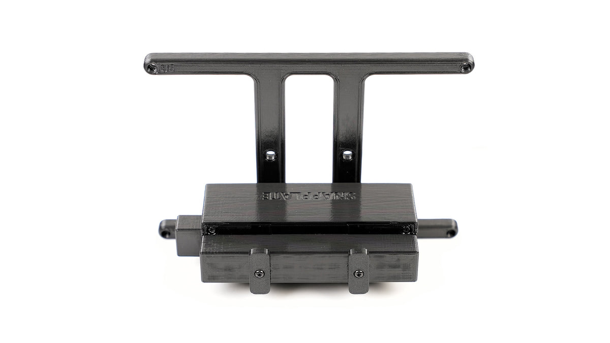 Black plastic bracket with two vertical extensions and three horizontal mounting points against a white background.