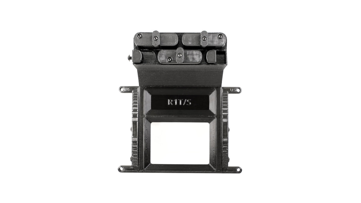 Black 3D-printed mechanical device featuring gears and levers, mounted on a rectangular frame, with RIT/3 embossed on the lower section.