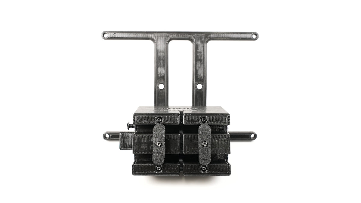A black mechanical device with multiple components, including two horizontal bars and several connectors, mounted on a bracket against a white background.