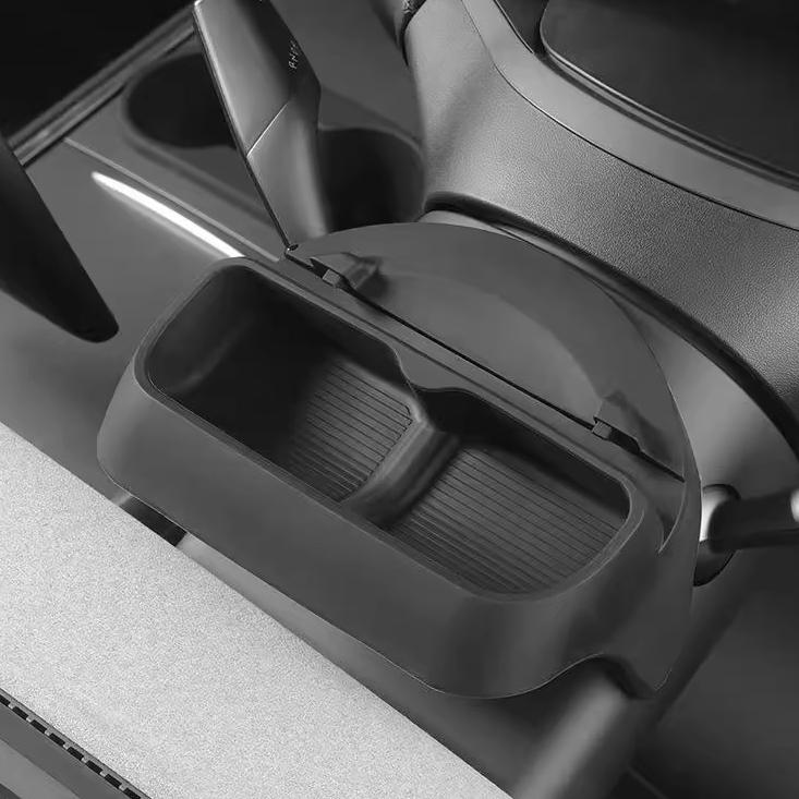 A close-up of the Tesery Official Store Sunglasses & Phone Holder Organizer for Model Y Juniper highlights its rectangular shape, textured interior, and convenient integration into your vehicle’s dashboard.