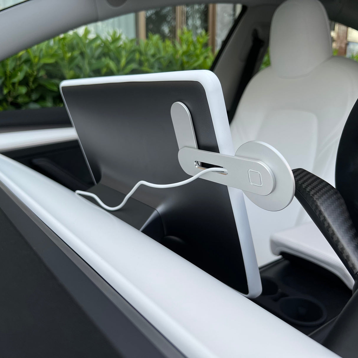 A close-up shows a Tesla’s rear seat screen with a cable plugged in, next to the Tesery Official Store Wireless Magsafe Mount for Model 3/Y/S/X/Cybertruck for enhanced convenience.