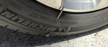 Tire with a nail through the sidewall