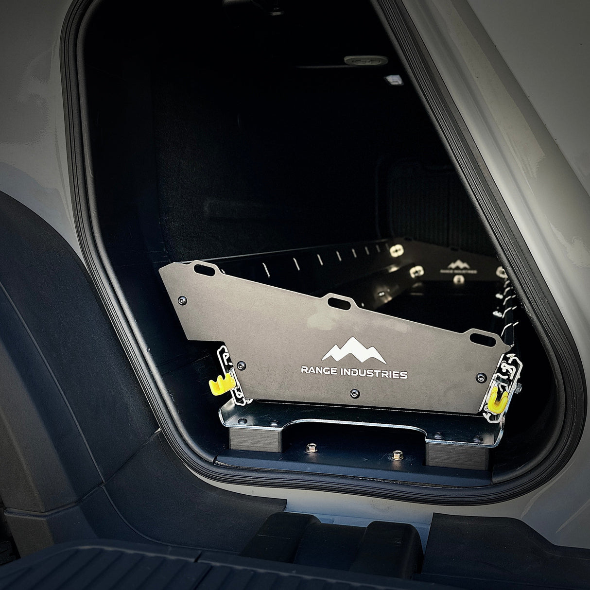 The Range Industries Gear Tunnel Slide 'LITE,' compatible with Rivian R1T, installs in the rear cargo area to provide convenient, organized access to your gear.