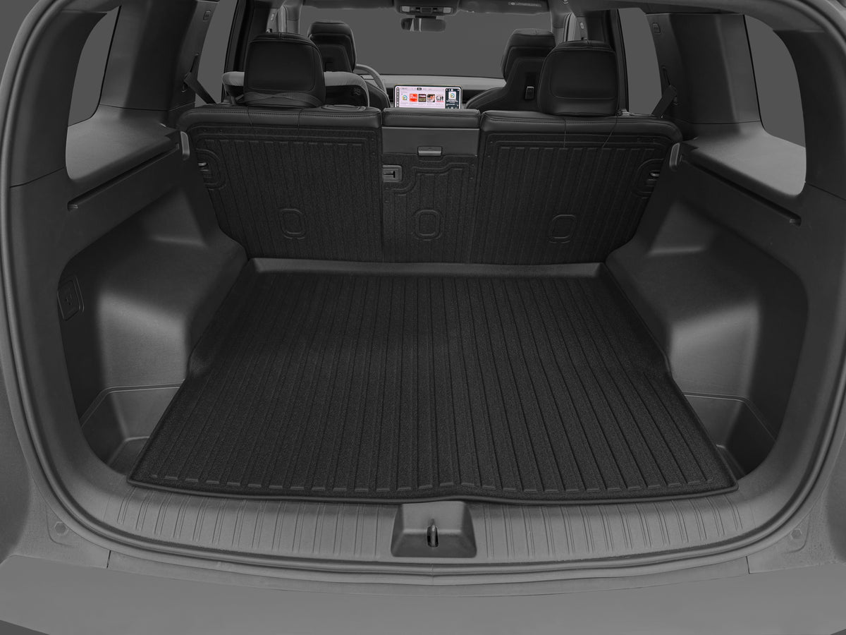 Custom-fit black rubber LinerX Seat Back Cover Mats for Rivian R2 (2027) cover the trunk floor and the back of the folded rear seats in an SUV.