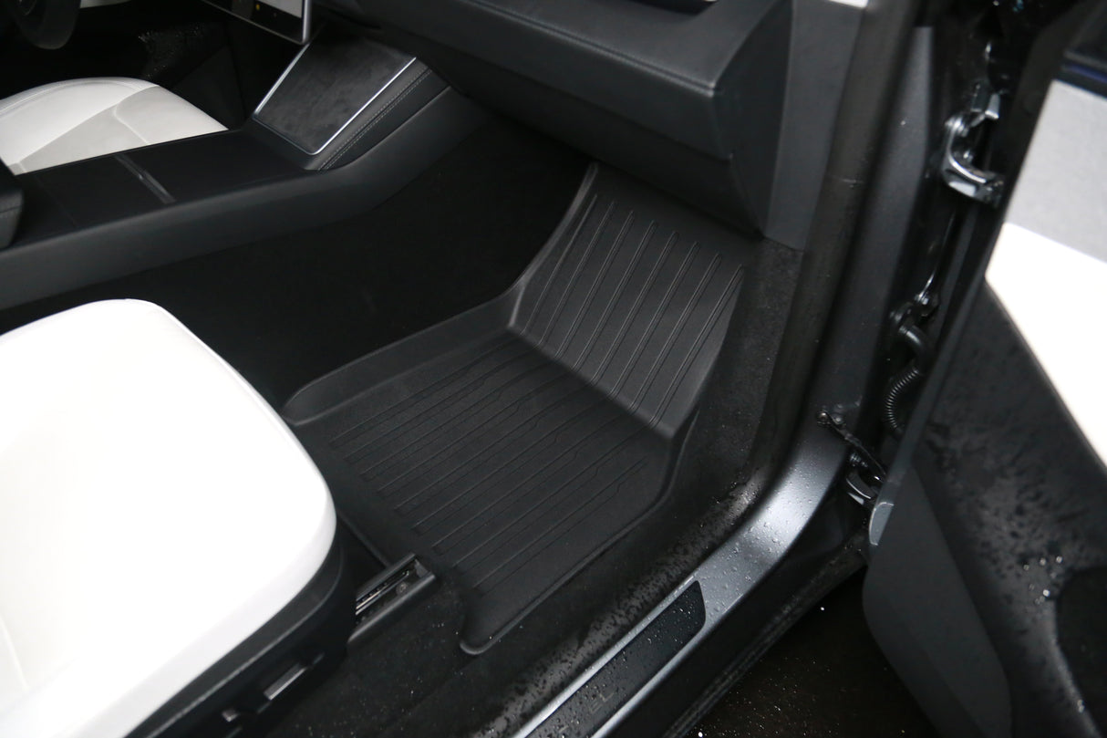 Interior view of a 2026 Tesla Model Y (Juniper) with white upholstery and eco-friendly LinerX Floor Mats, including a sleek black mat from LinerX.