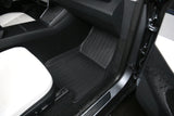Interior view of a 2026 Tesla Model Y (Juniper) with white upholstery and eco-friendly LinerX Floor Mats, including a sleek black mat from LinerX.