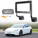 An EveryAmp Tesla Model 3 SnapPlate Front License Plate Holder, crafted from durable 3D printed PETG and including tools with a pouch, is shown above a white Tesla parked on the street.
