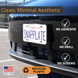 The EveryAmp Tesla Model Y SnapPlate Front License Plate Holder is shown mounted on a car—no adhesive, no drill, no screws needed. Made in the USA from recycled 3D-printed PETG, it’s an easy and eco-friendly solution.