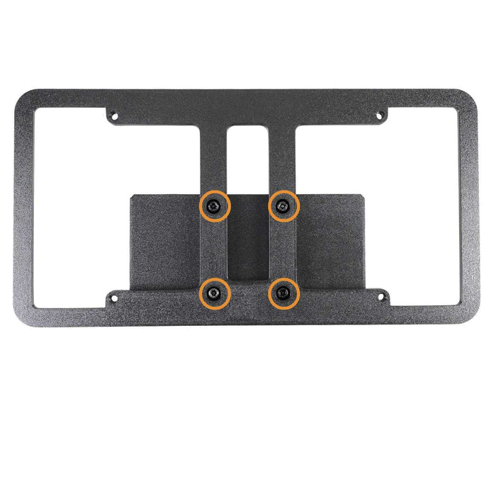 A black rectangular metal mounting bracket with four screws and orange washers, viewed from above on a white background.