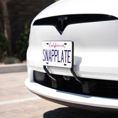A white Tesla Model X sports a California plate reading SNAPPLATE, mounted with an EveryAmp Tesla Model X SnapPlate Front License Plate Holder made from black 3D-printed PETG.