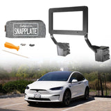 An EveryAmp Tesla Model X SnapPlate Front License Plate Holder with tools and hardware is shown above a white Tesla Model X parked outdoors, featuring the 3D-printed holder installed on the vehicle’s front.